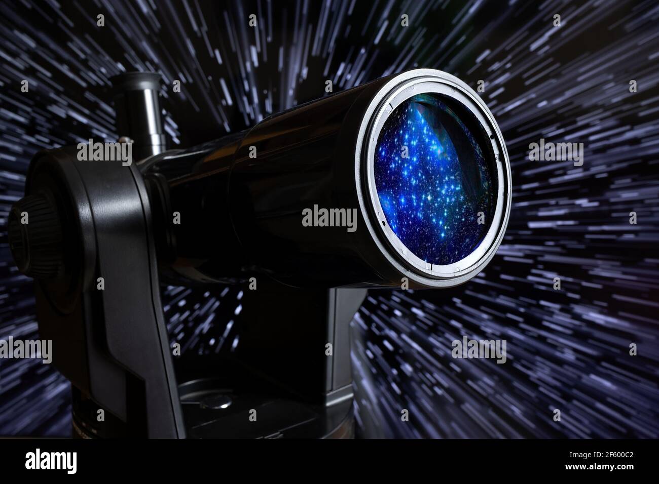 Using a small telescope to observe the stars behind a starry background Stock Photo