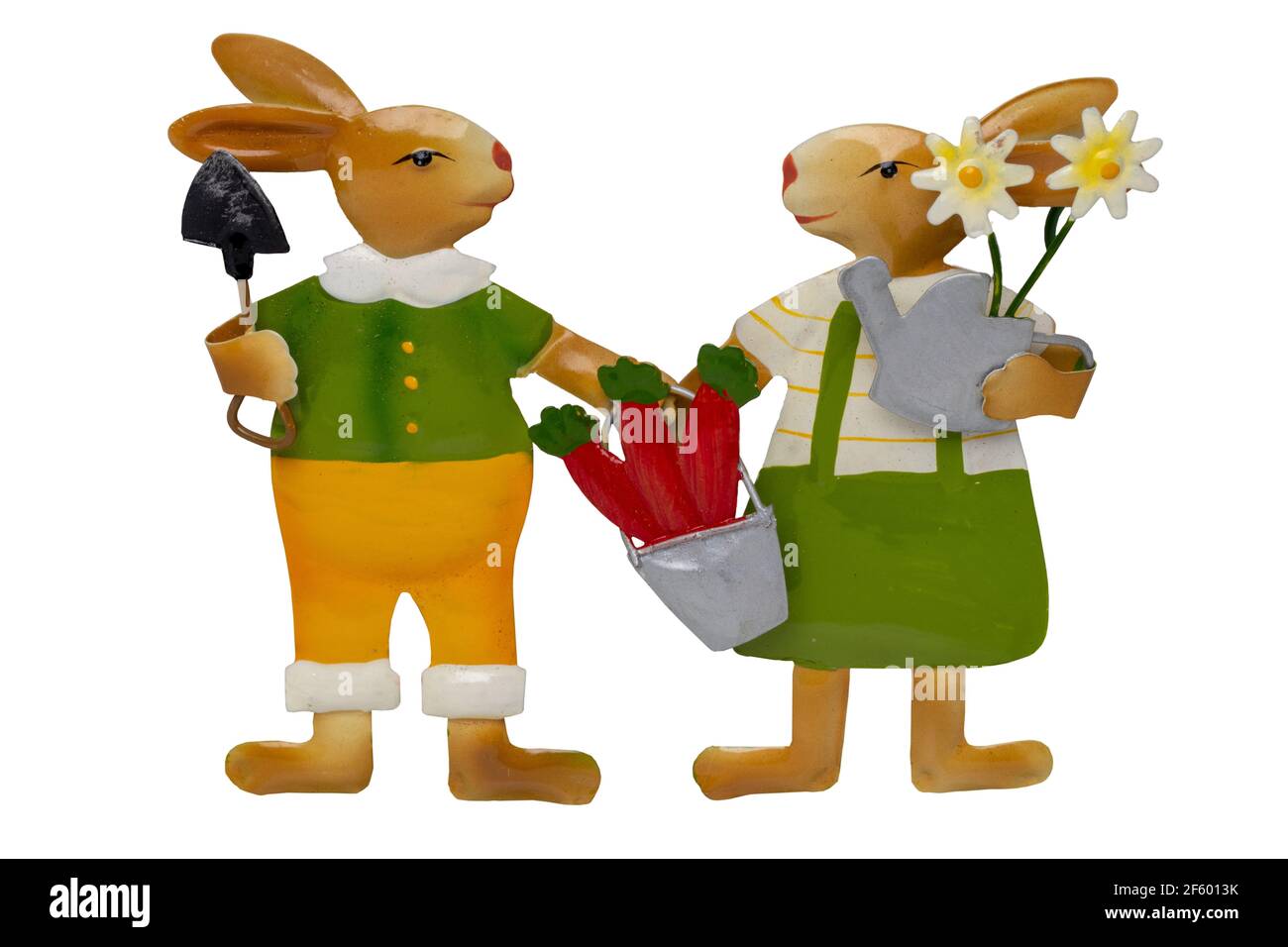 Easter decoration element. Close-up of two bunnies with garden tools and flowers isolated on a white background.  Handmade and then painted. Macro. Stock Photo