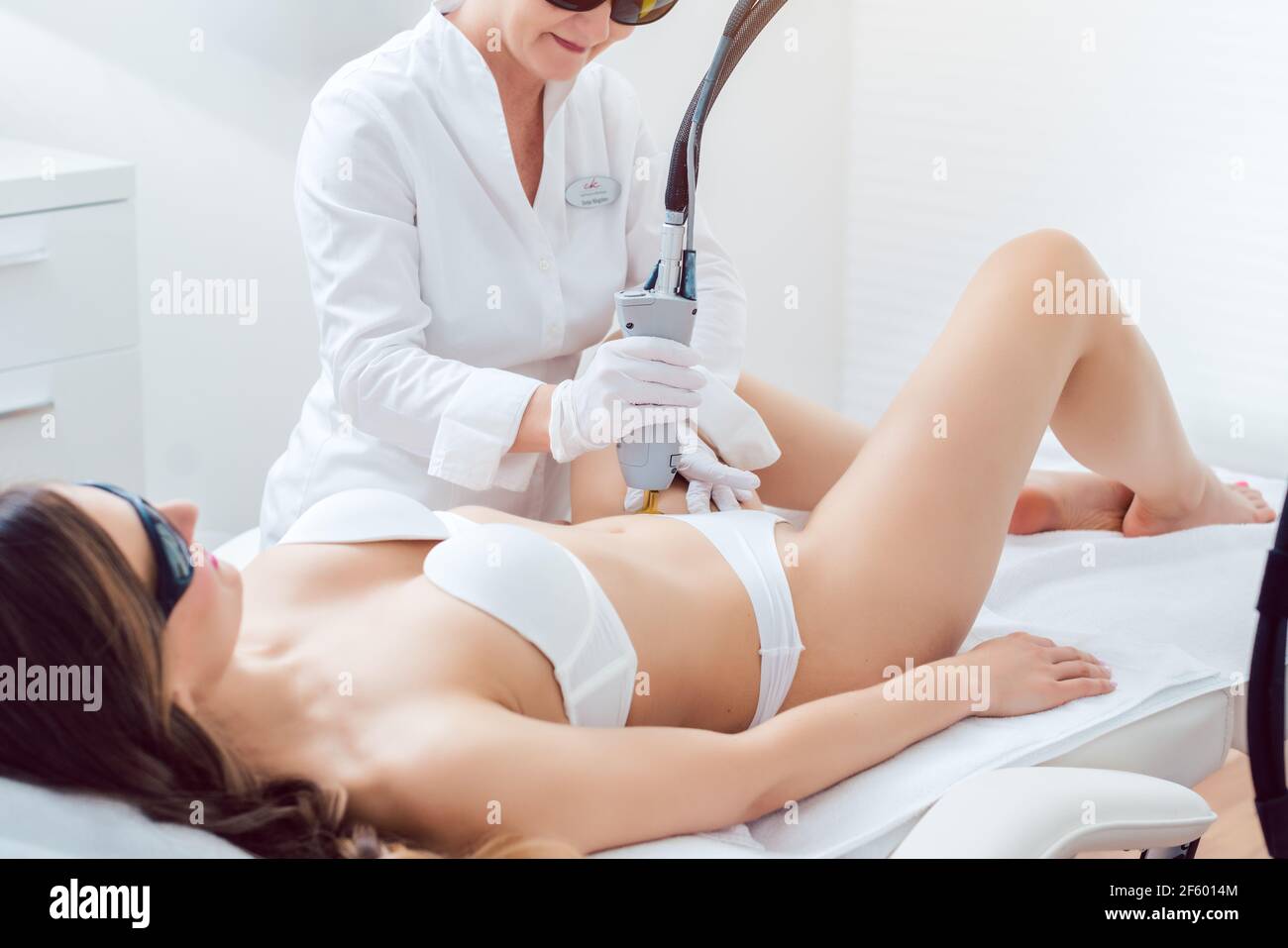 therapist using painless laser technology for hair removal Stock Photo