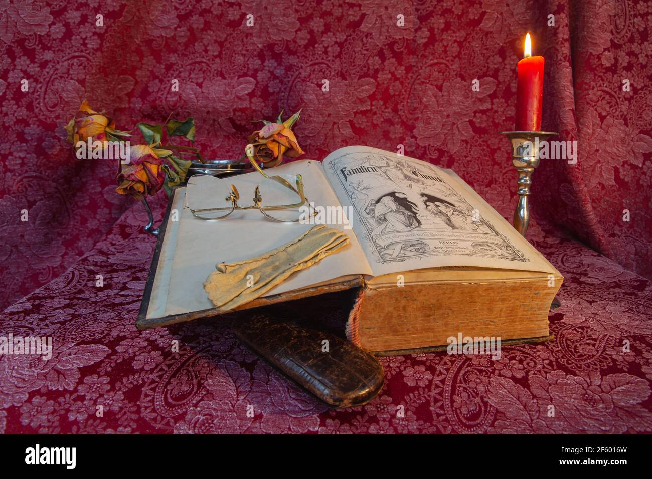 Book, old book, close up view, still life, Nahaufnahme, Detailaufnahme, Dateil shot, Arangement, Kerzenhalter, wilted flower, flower, Stillleben Stock Photo