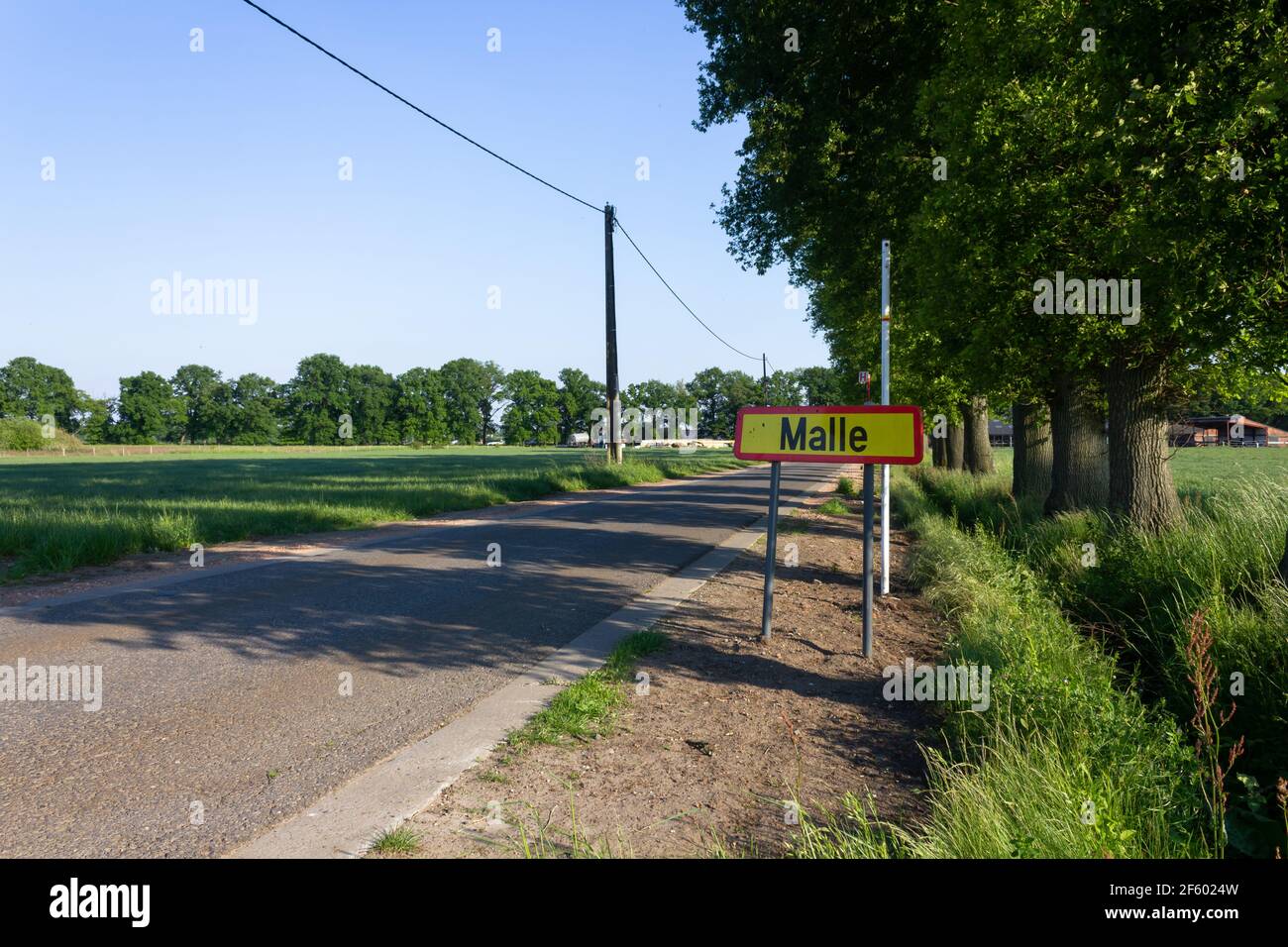 Town sign of Malle next to rural road on a sunny day (Antwerp, Belgium) Stock Photo