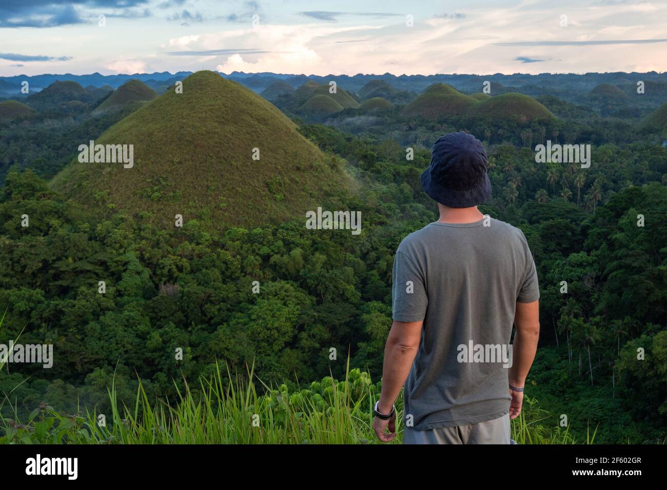 Traveler looking at view at natural landmark Chocolate Hills in Bohol island, Philippines. Stock Photo