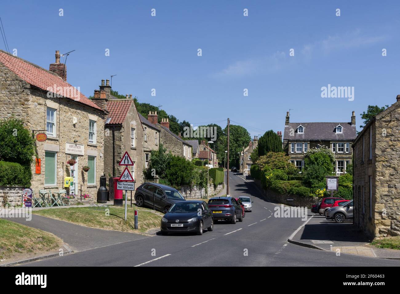 Street scene in summer in the village of Ampleforth, Yorkshire, UK; with the Post Office and Stores to the left hand side. Stock Photo