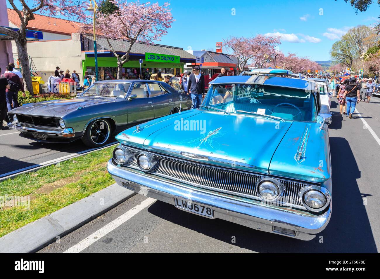 Classic cars at an outdoor car show. A blue 1960 Mercury Commuter next to a purple 1973 Ford Fairmont Stock Photo