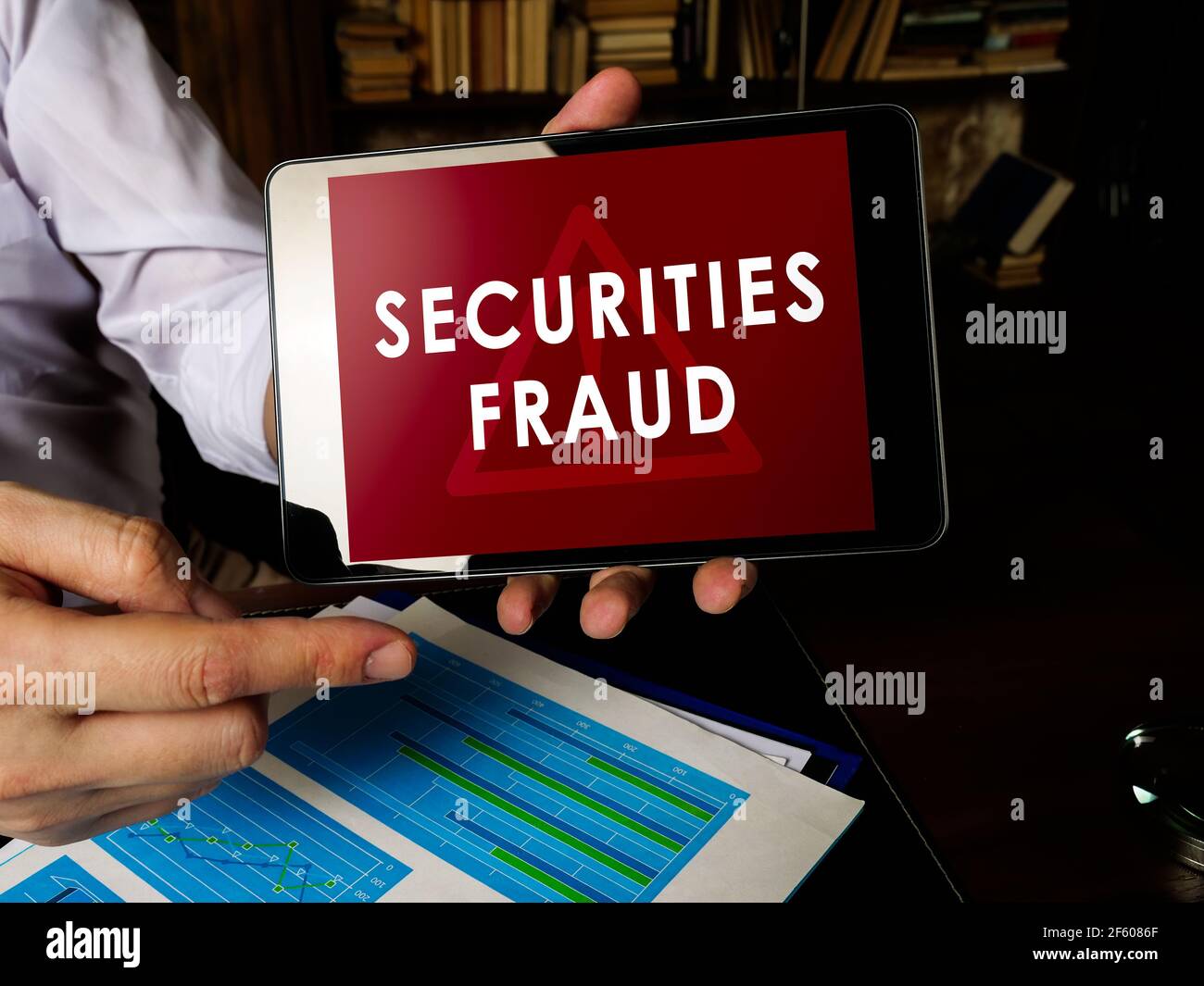 Manager shows Securities fraud alert on the tablet. Stock Photo
