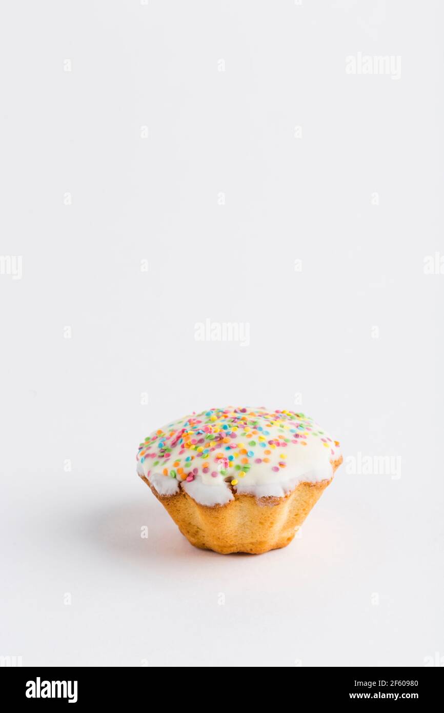 Muffin with chocolate icing and jam on a white background, isolated. Close-up with a copy space for the text. Stock Photo