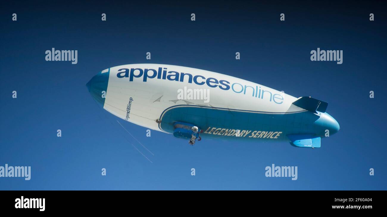 The unique blue and white Legend Blimp, advertising Appliancesonline, over Brisbane, Australia in 2016. The only blimp in the southern hemisphere. Stock Photo