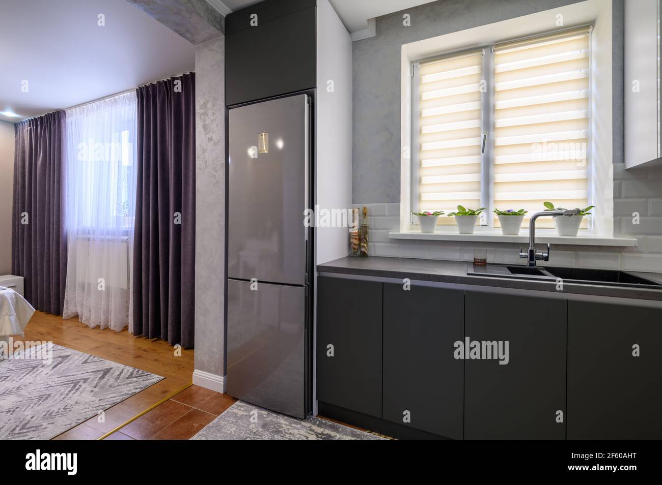 Modern dark grey small kitchen interior Stock Photo - Alamy