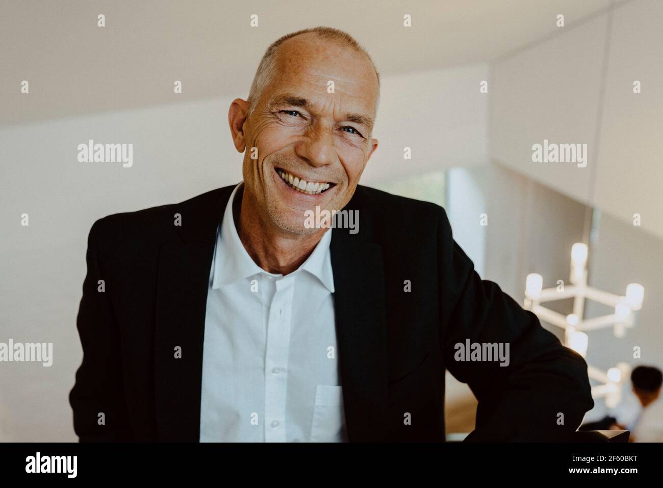 Portrait of smiling businessman in office Stock Photo - Alamy