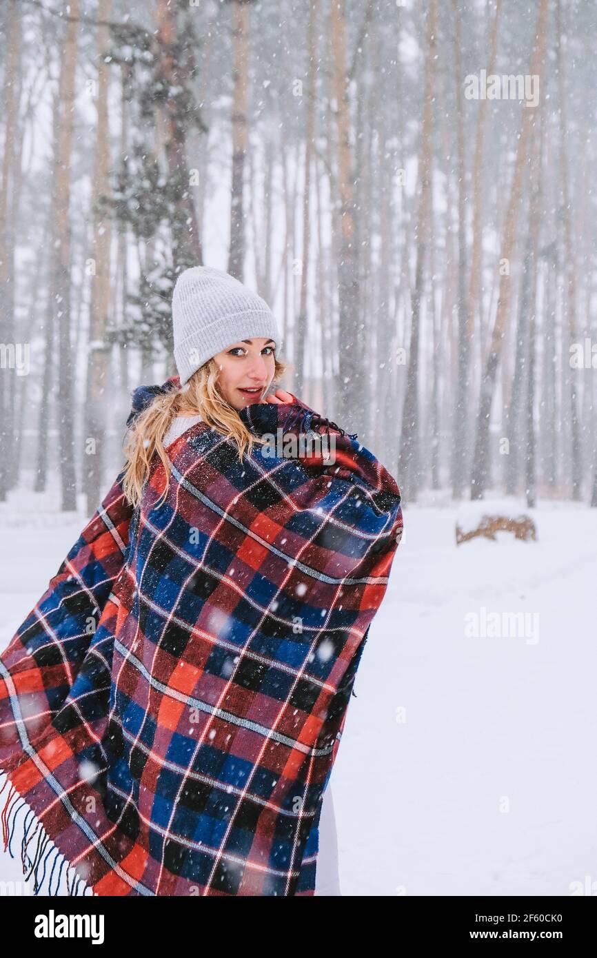 Dancing woman traveling among forest wearing hat and poncho, boho and  wanderlust style. Winter is coming, first snowfall. Cold weather. Winter  landscape Stock Photo - Alamy