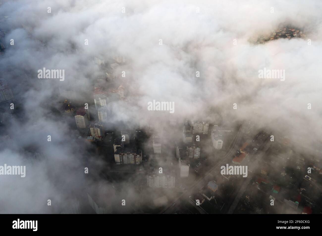 Top aerial view of fluffy white clouds over modern city with high rise ...