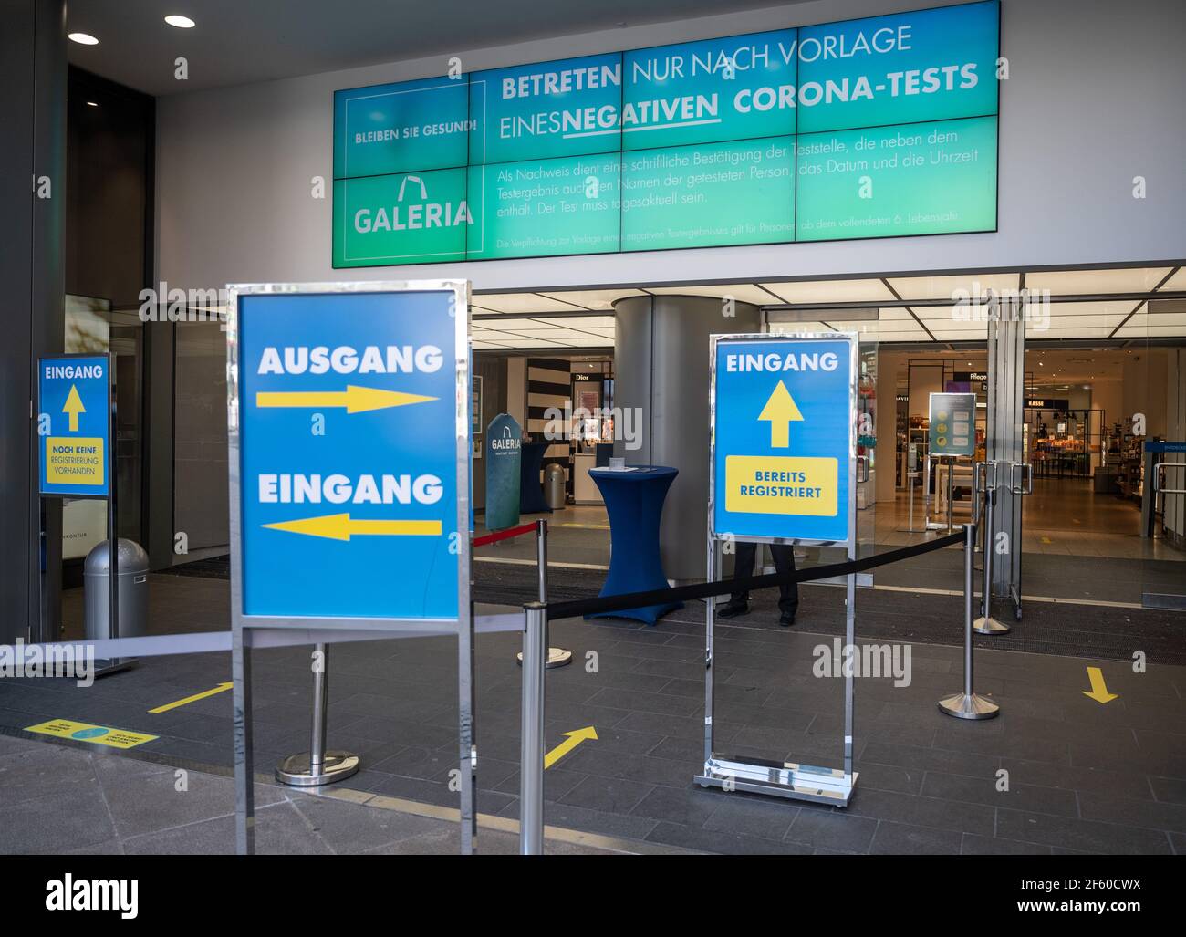 Dortmund, Germany. 29th Mar, 2021. The entrance of a Galeria Kaufhof store, in front of which a sign indicates that entry is only possible after a negative Corona test has been presented. A new Corona protection regulation comes into force in NRW. Credit: Bernd Thissen/dpa/Alamy Live News Stock Photo