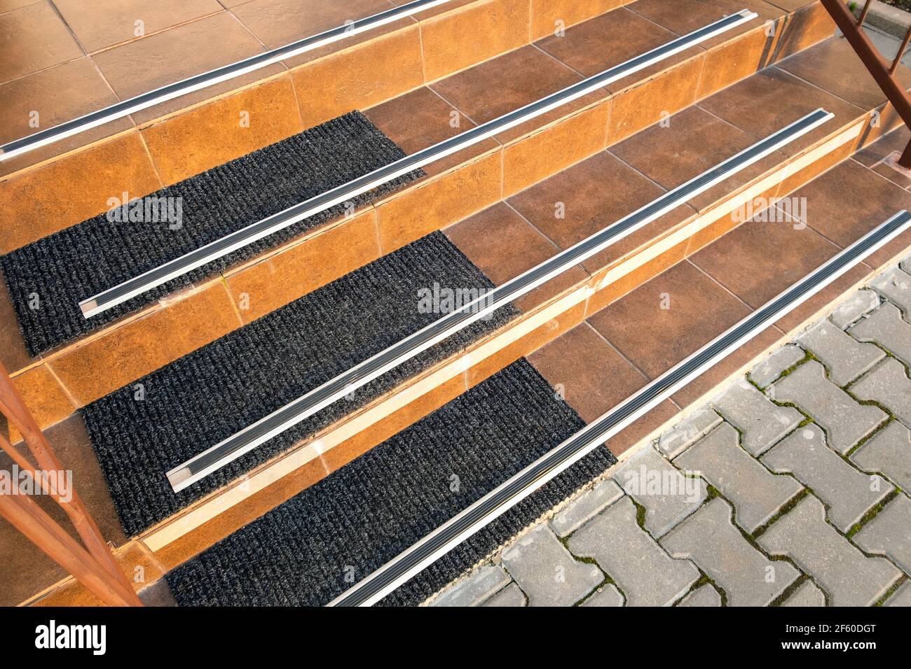 Closeup of ceramic tiles covering porch stairs with rubber anti