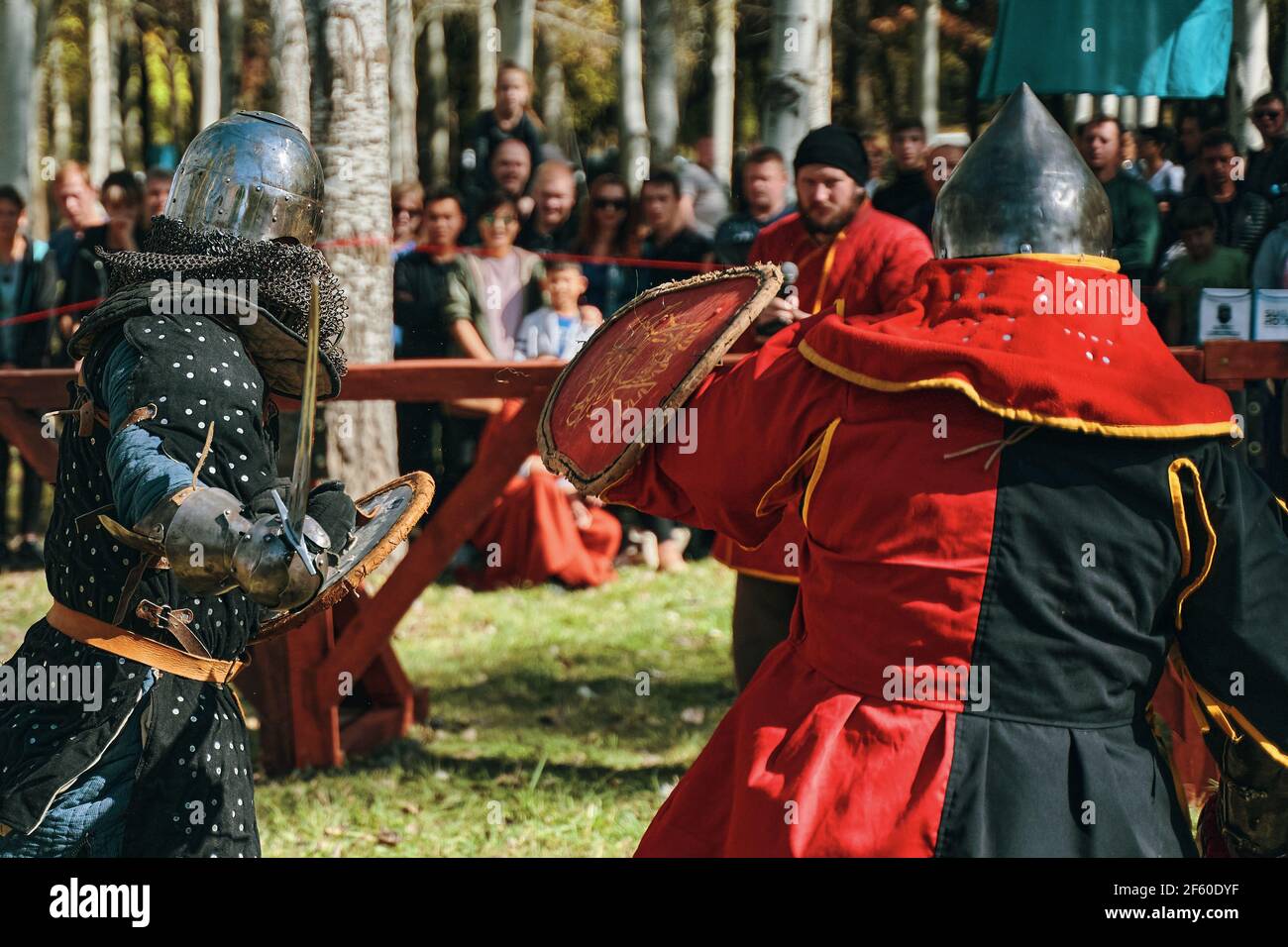 A knight in black armor against a knight in red armor in the arena
