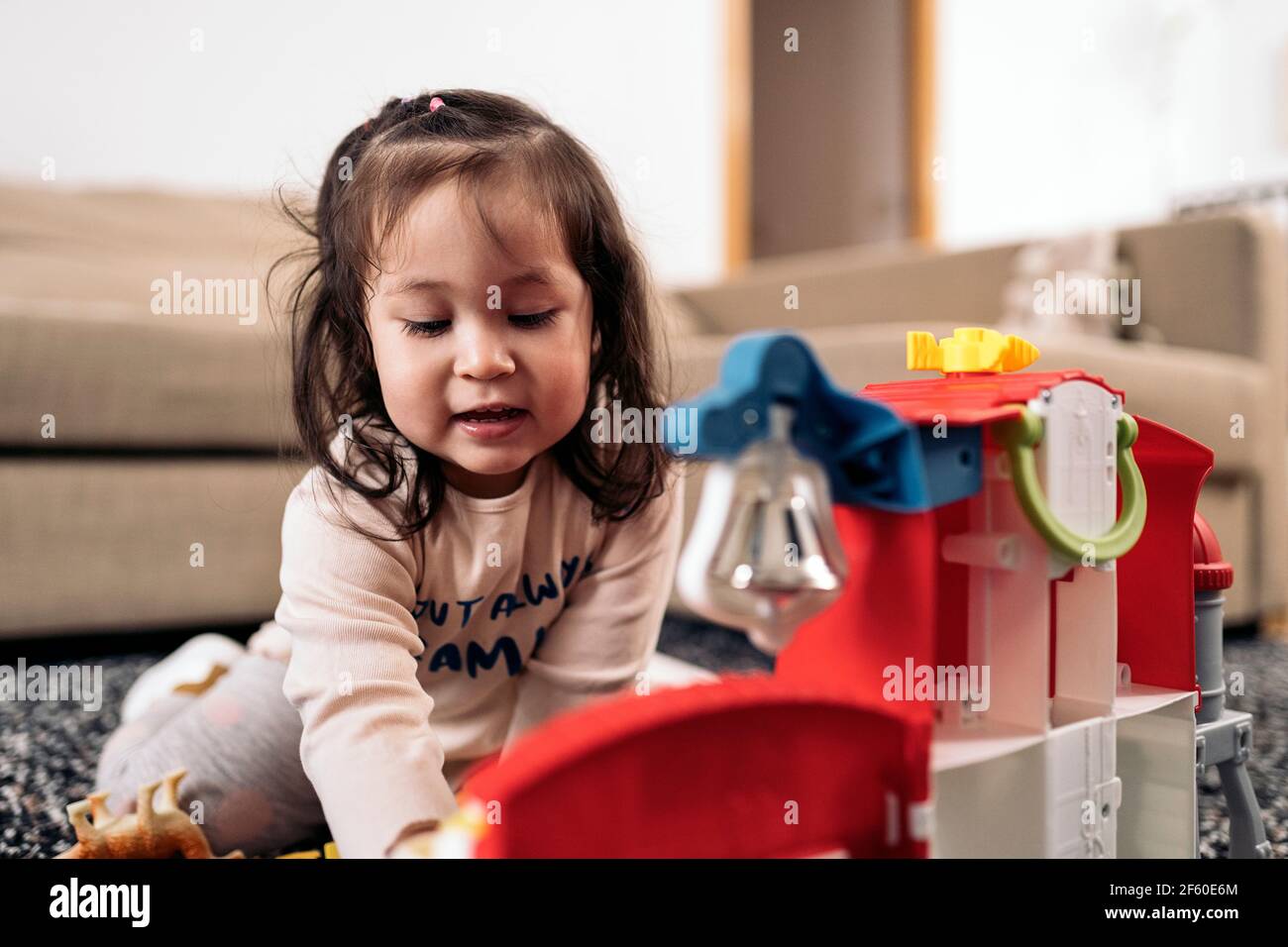 Stock photo of cute little girl having fun at home playing with her ...