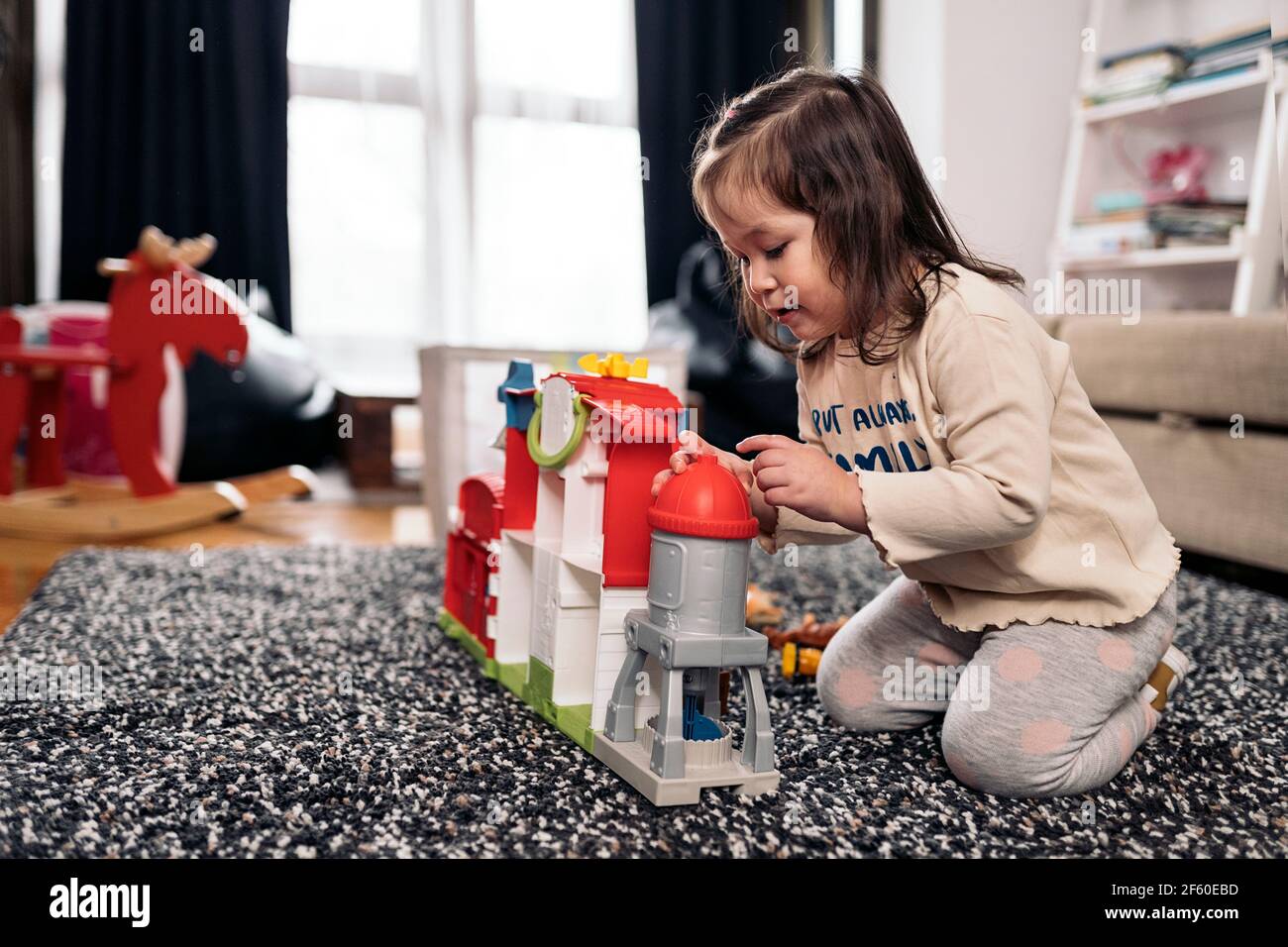 Stock photo of cute little girl having fun at home playing with her ...
