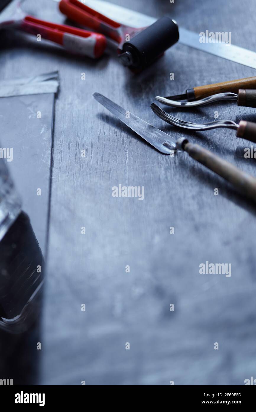 Art and crafts - linocut tools on white paper Stock Photo - Alamy