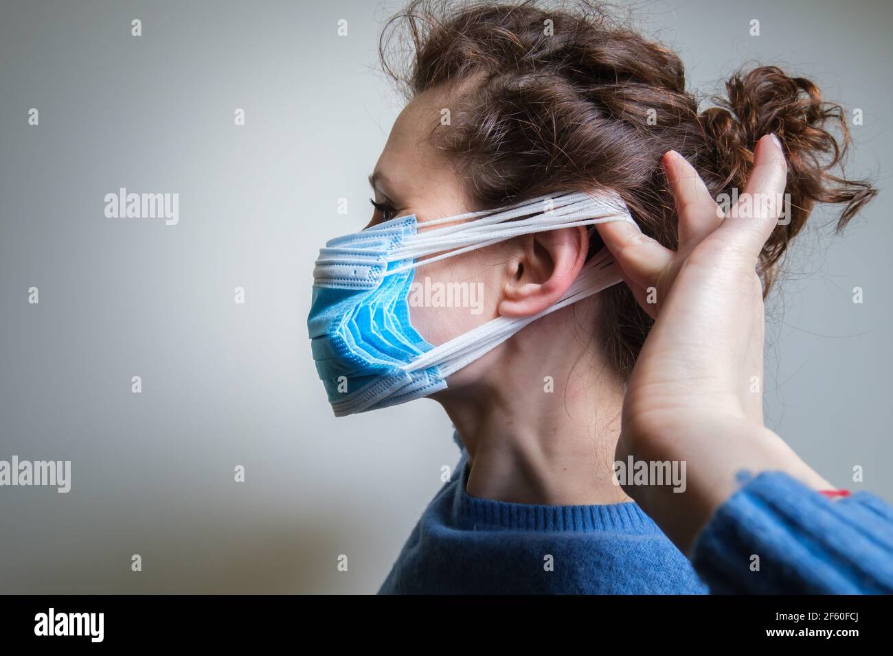 Girl puts mask on face hi-res stock photography and images - Alamy