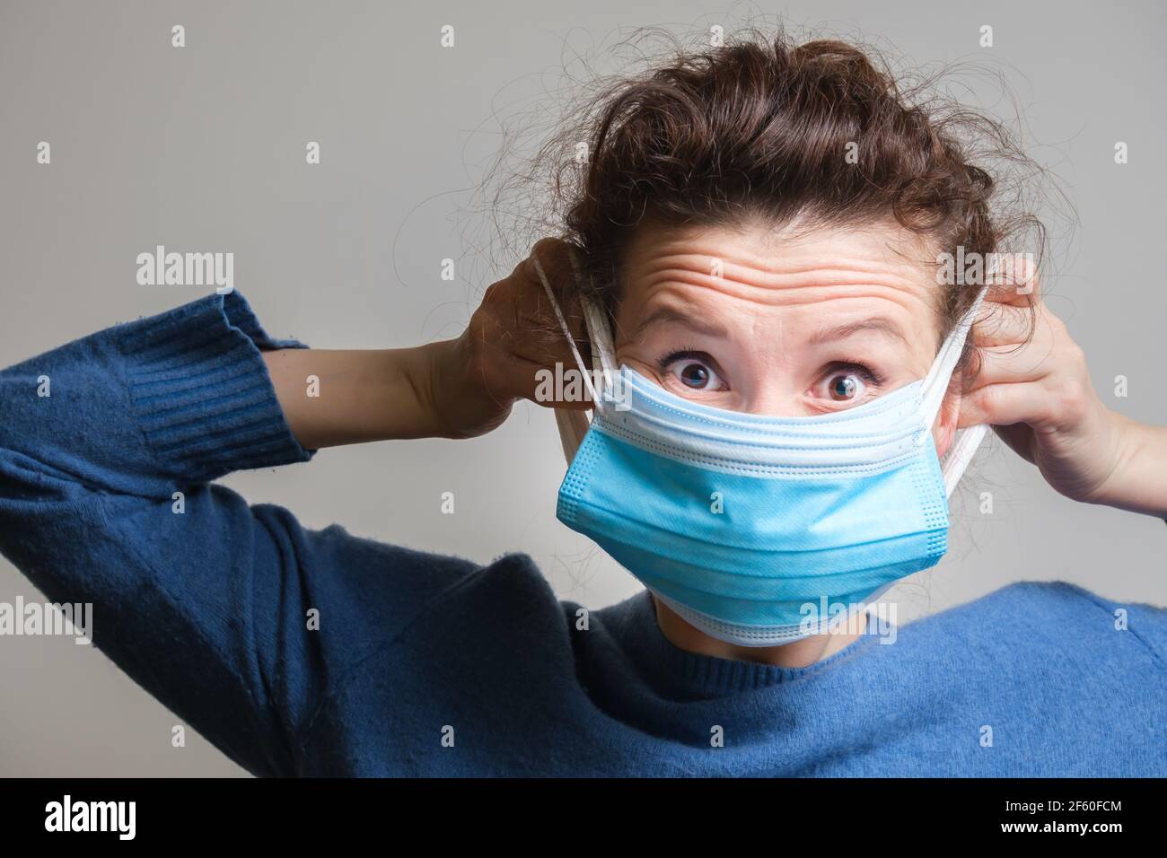 Girl puts mask hi-res stock photography and images - Alamy