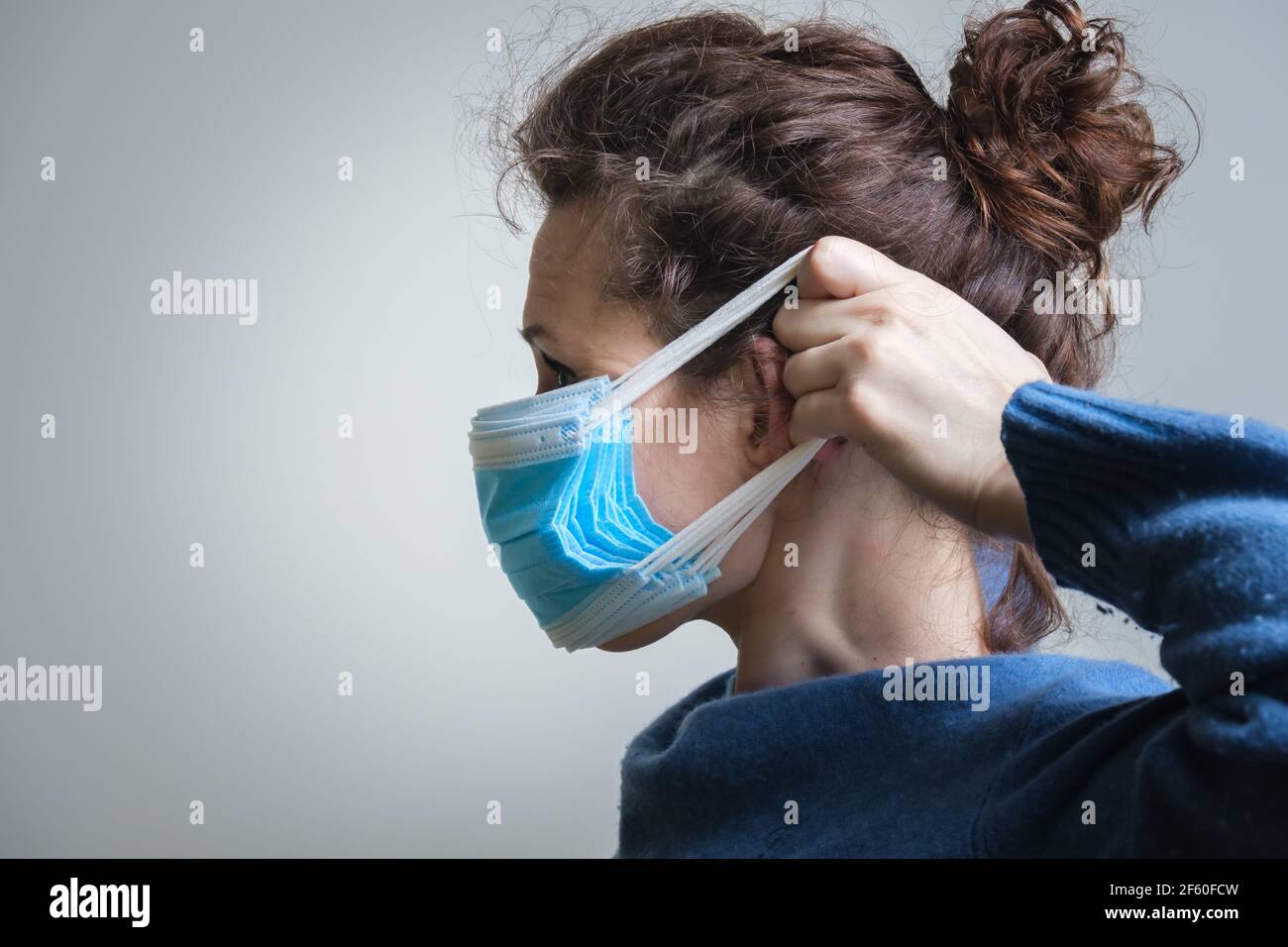 Girl puts mask hi-res stock photography and images - Alamy