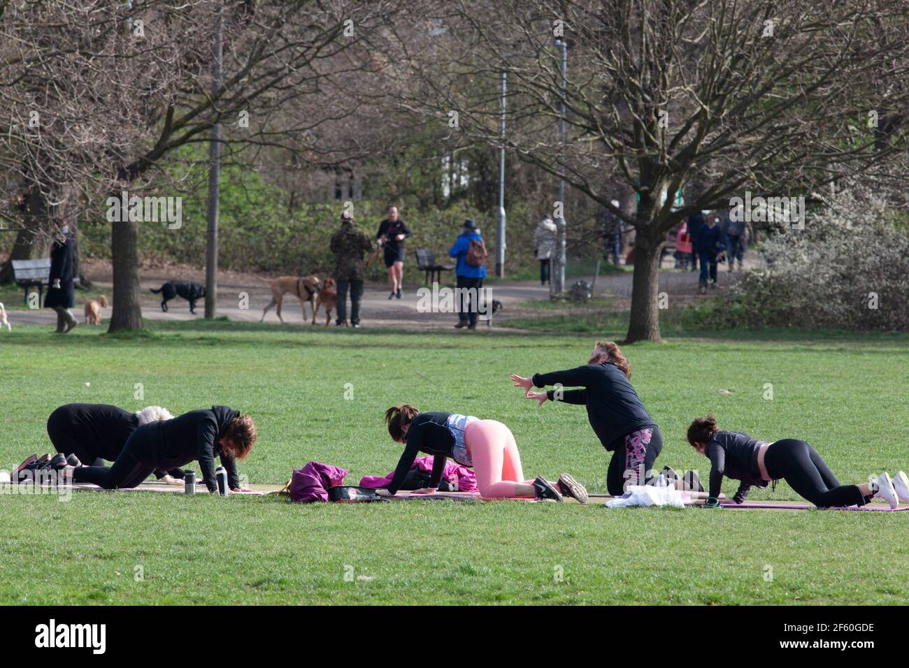 London, UK, 29 March 2021: On Tooting Commons a group of women take an outdoor exercise class, which from today is permitted under the gradual easing of lockdown rules in England. Anna Watson/Alamy Live News Stock Photo