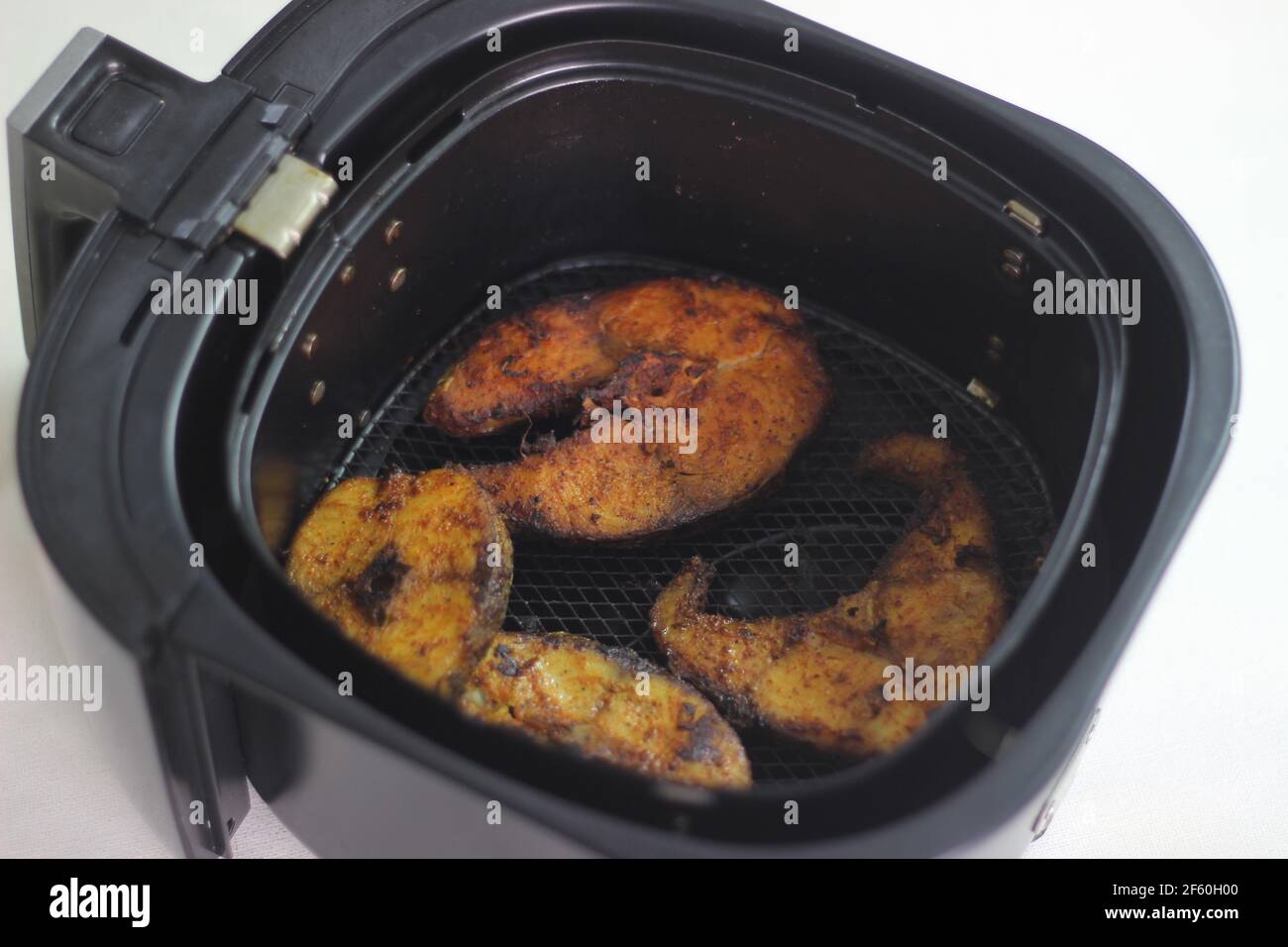 Cobia fish inside the air fryer. In India it is called Moda fish. Other common names include black kingfish, black salmon, ling, lemonfish, crabeater, Stock Photo