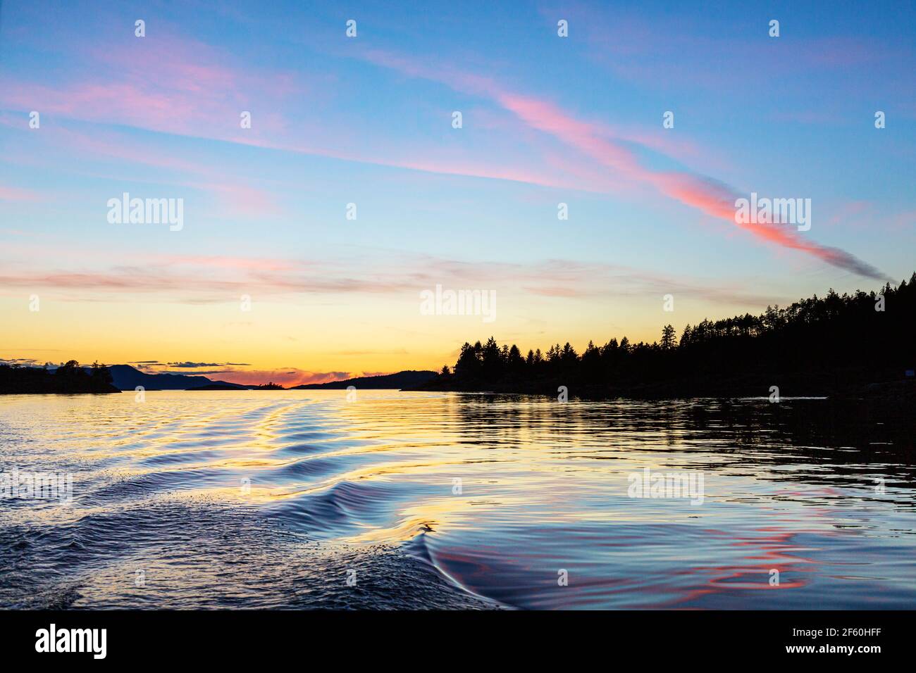 Sunset over the copeland Islands from a boat from Lund on the strait of Georgia Stock Photo