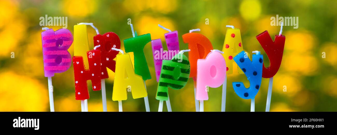 Colorful happy birthday candles with nature background Stock Photo - Alamy