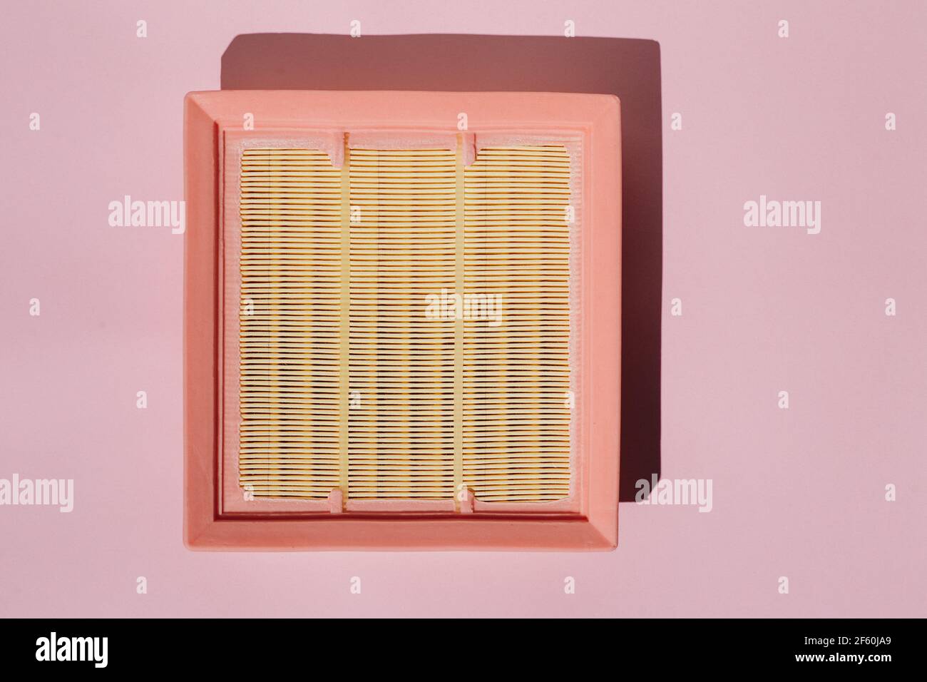 New car air filter on a pink background. Stock Photo