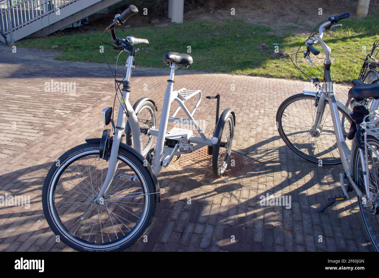 Arnhem, Netherlands March 5, 2021 White tricycle bike parked at an