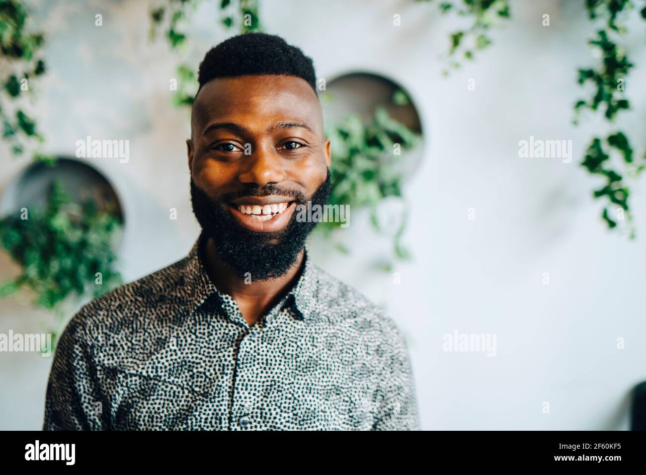 Portrait of smiling businessman in office Stock Photo