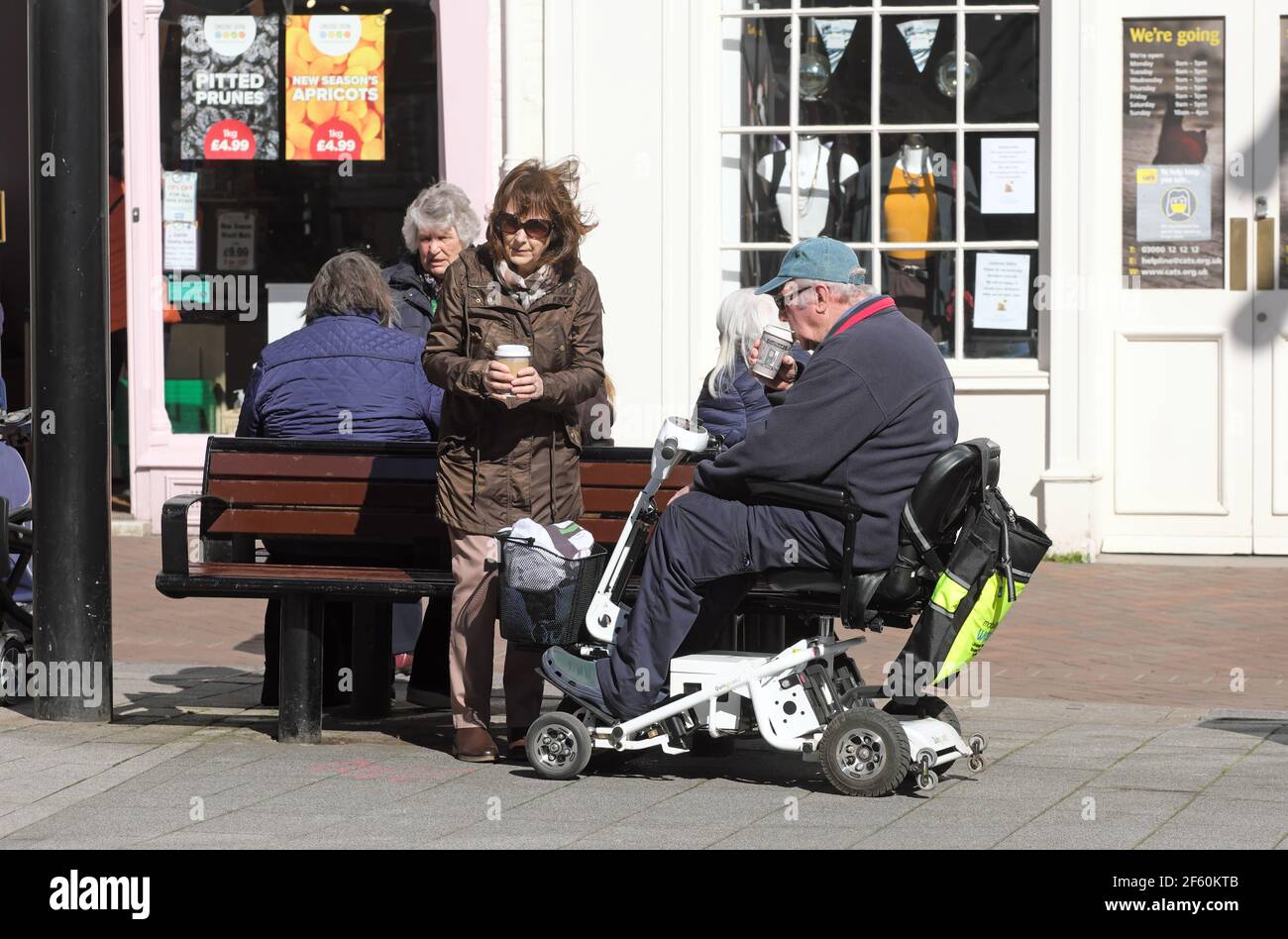Hereford, Herefordshire UK - Monday 29th March 2021 - People meet up in Hereford city centre to enjoy an outdoor cup of coffee on a lovely sunny Spring day as Coronavirus restrictions are eased to allow up to six people from two households to meet outdoors. Photo Steven May / Alamy Live News Stock Photo