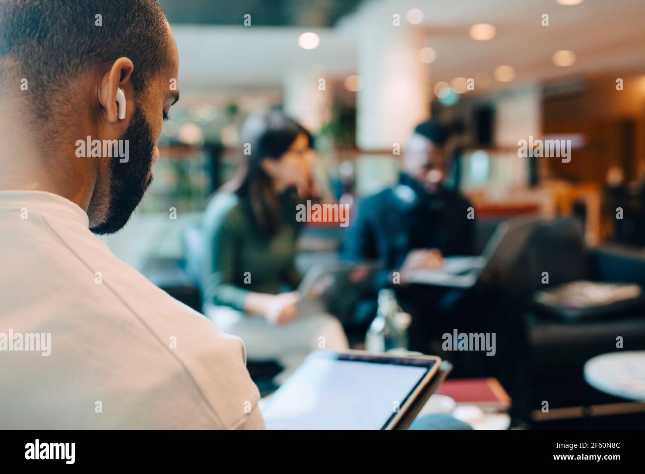 Businessman using digital tablet while sitting in office Stock Photo