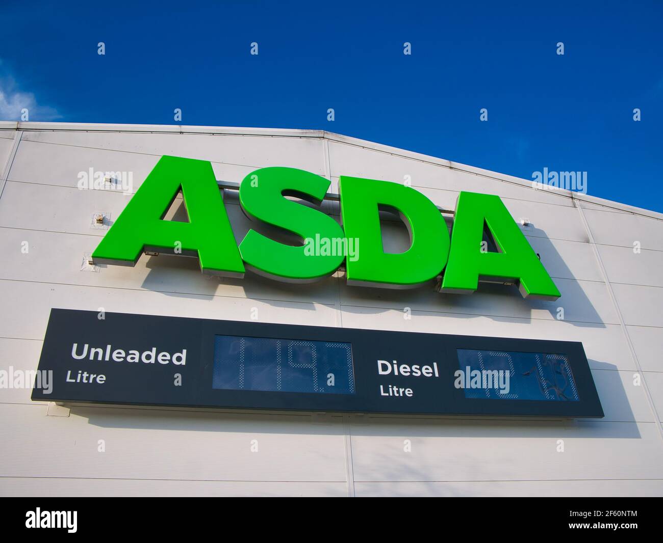 Corporate signage and diesel and unleaded fuel price displays at a store of the ASDA British supermarket chain Stock Photo