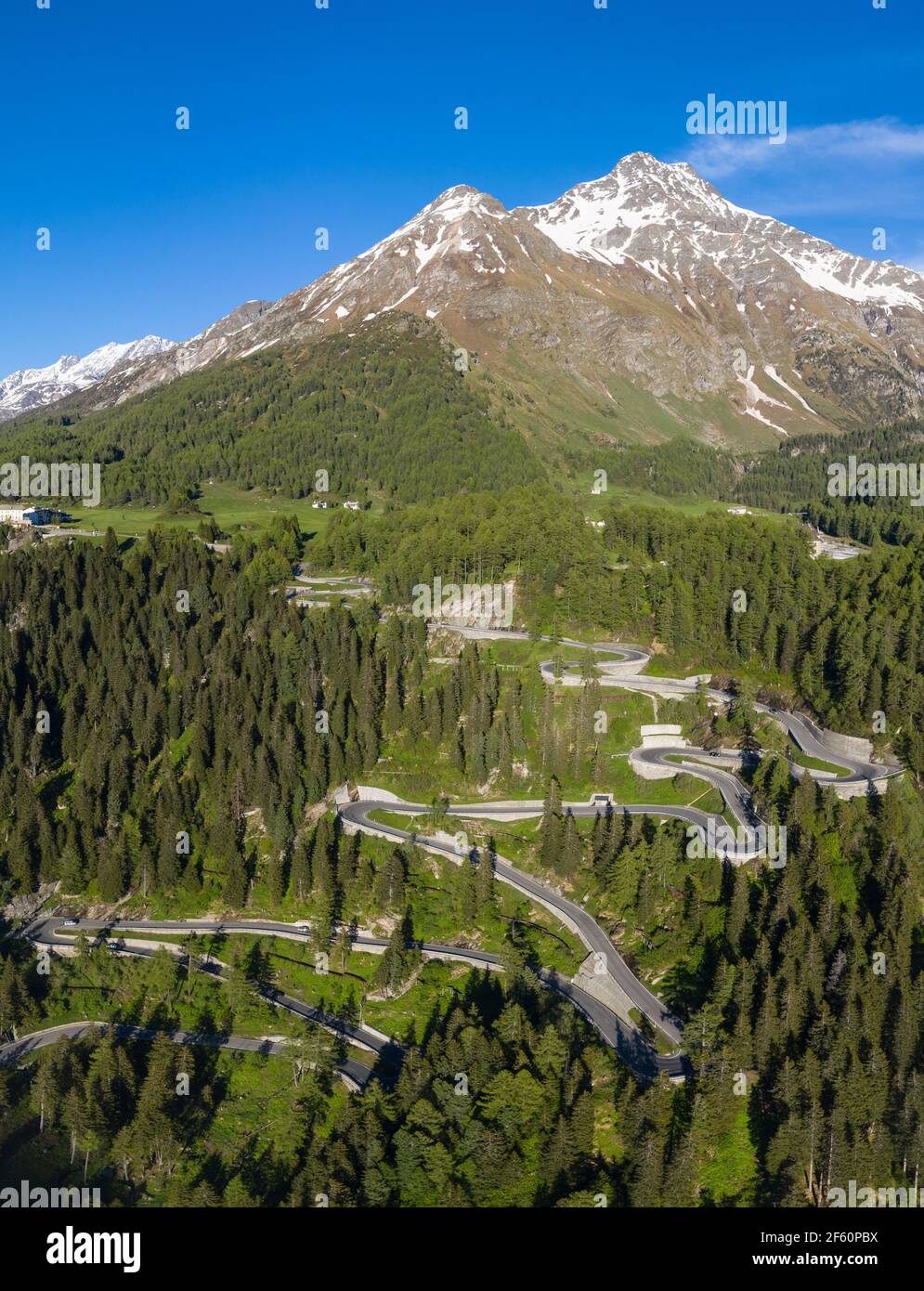 Dramatic aerial view of the Maloja mountain pass road in the Engadine valley in the alps in Canton Graubunden in Switzerland on a sunny summer day. Stock Photo