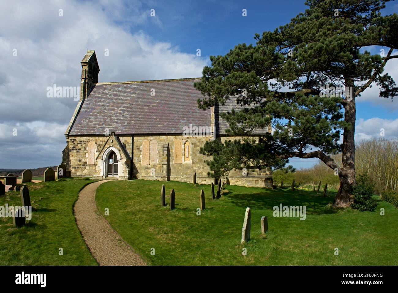All Saints Church (with windows boarded up), in the village of Burythorpe, North Yorkshire, England UK Stock Photo