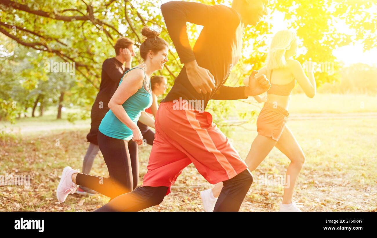 Group of young friends at cross country training for fitness in summer in nature Stock Photo