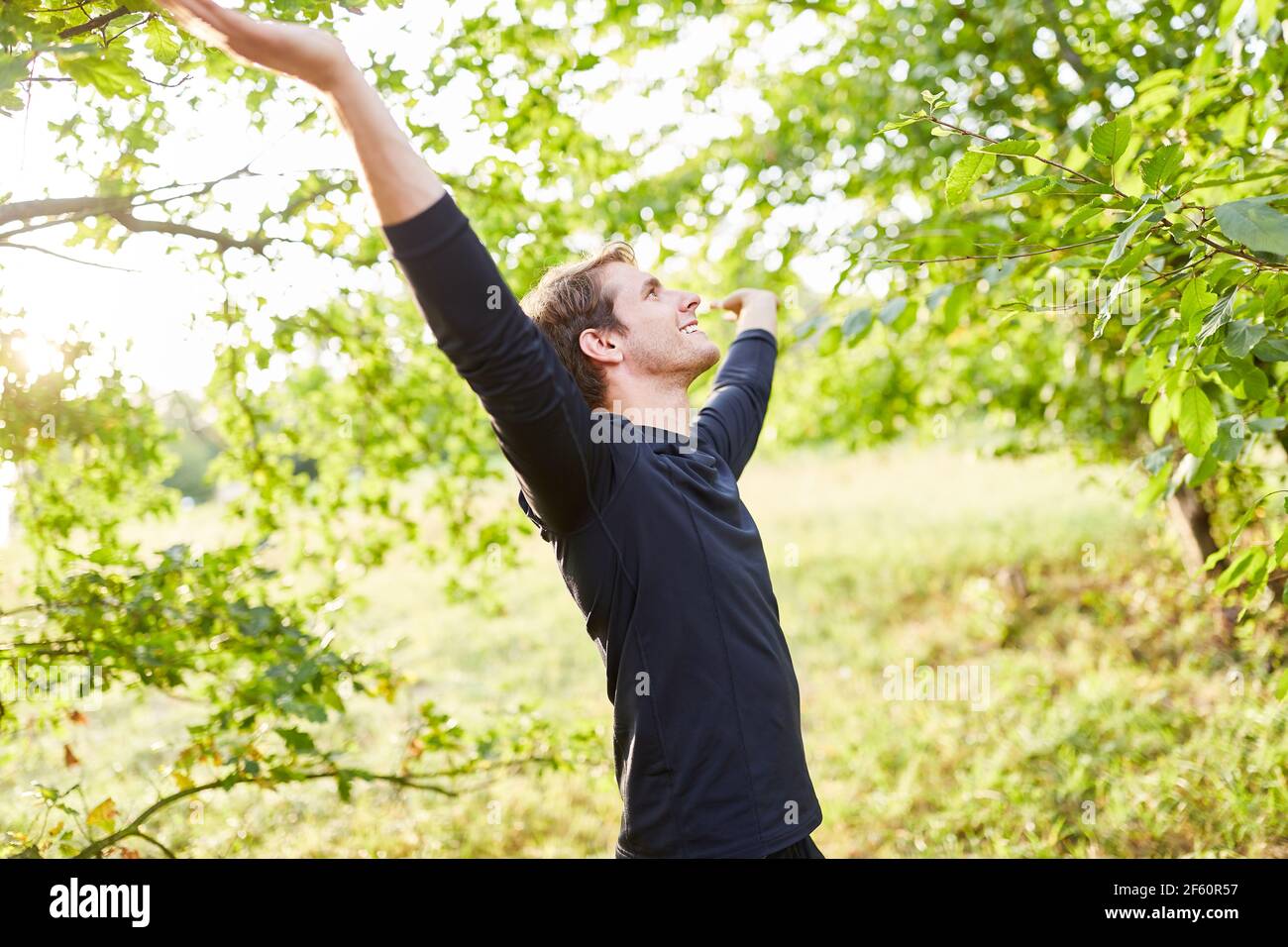 Young man doing a fresh air breathing exercise for stress relief and relaxation Stock Photo