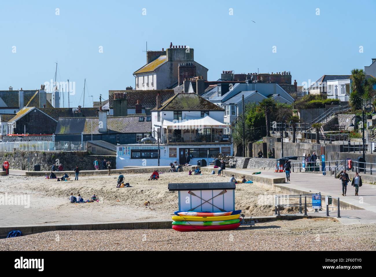 Lyme Regis, Dorset, UK. 29th Mar, 2021. UK Weather: The seaside resort of Lyme Regis basks in glorious warm spring sunshine as the coronavirus lockdown restrictions ease toay. Temperatures are set to soar with the south coast seeing sizzling conditions this week. Credit: Celia McMahon/Alamy Live News Stock Photo
