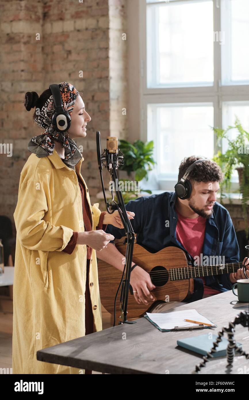 Couple of artists performing together in recording studio Stock Photo