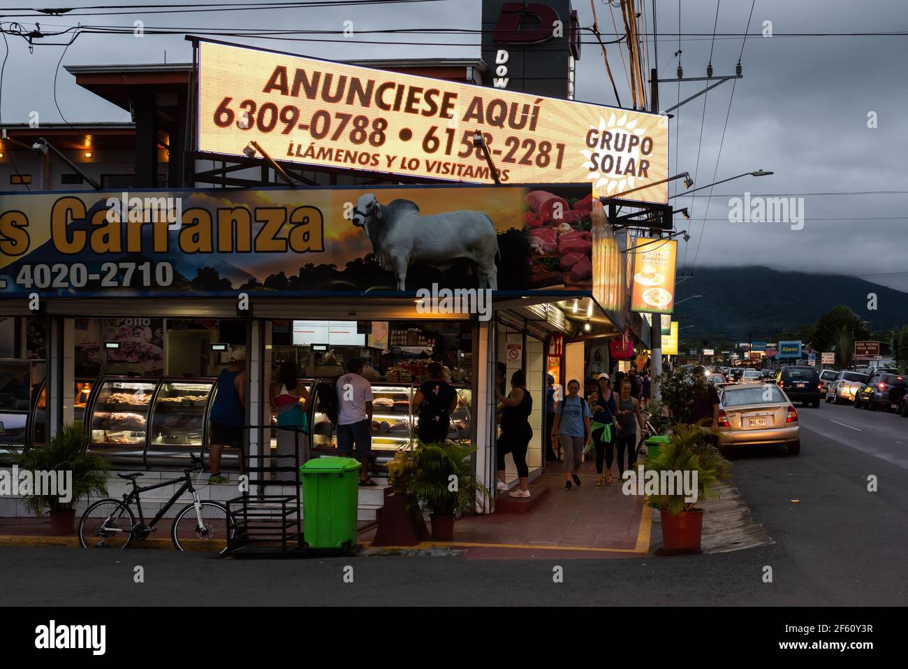 La Fortuna city, Costa Rica. Street scene at dusk with Arenal Volcano in background. Stock Photo