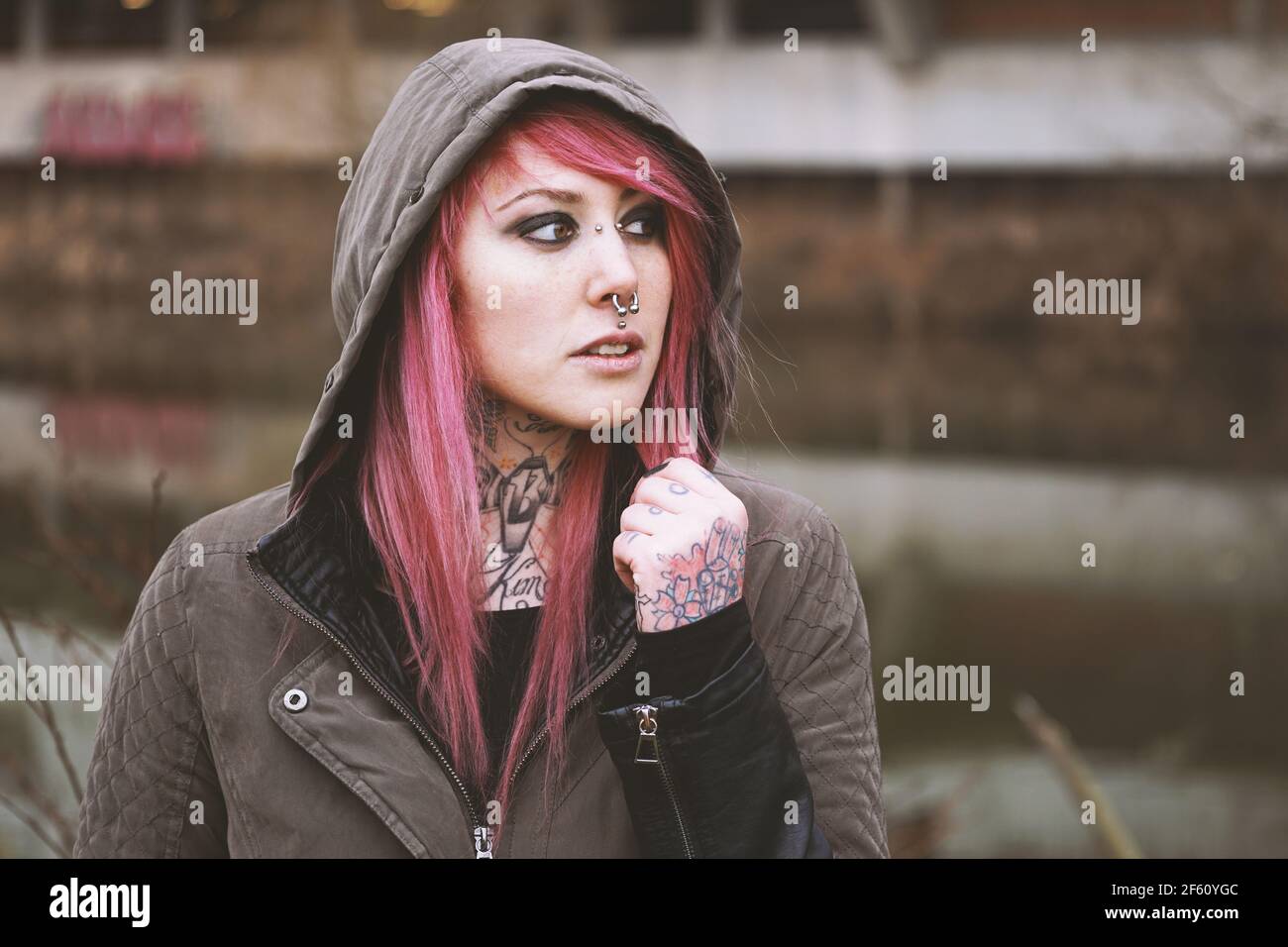 thoughtful portrait of young woman with piercings and tattoos Stock Photo