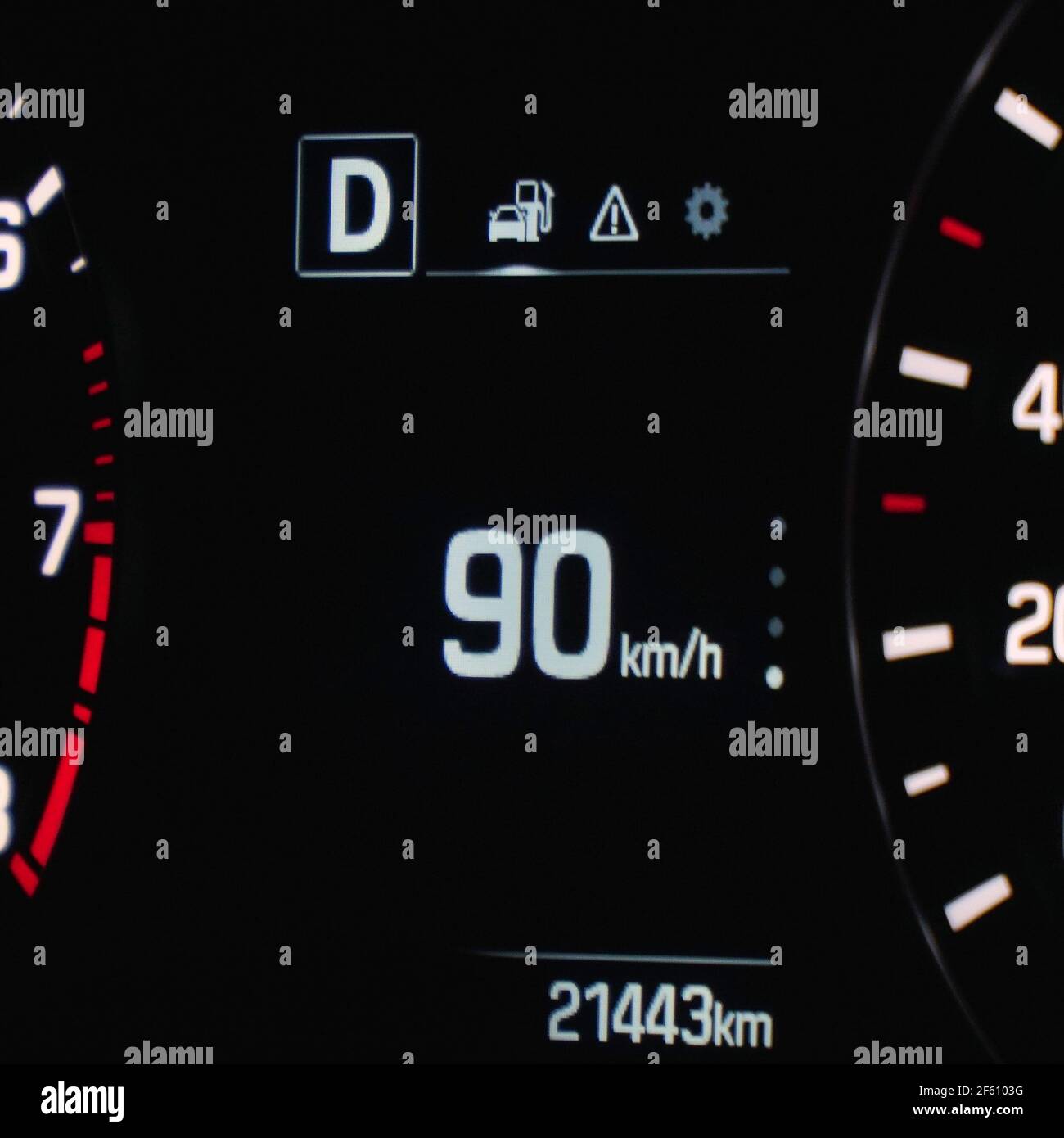 Speedometer in the car on the dashboard. The car's speedometer shows 90