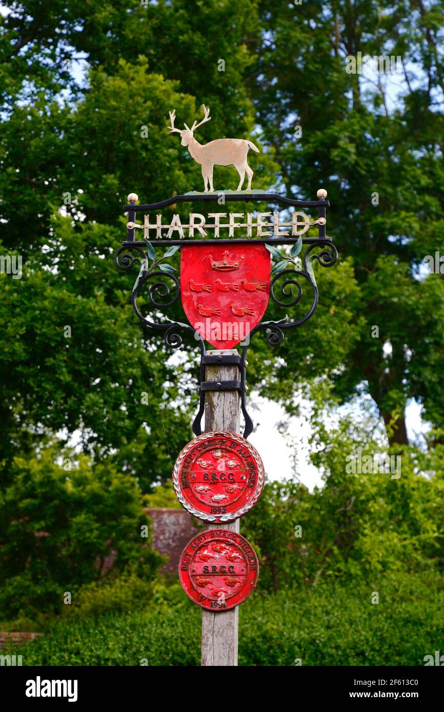 Detail of village sign with golden hart, county council coat of arms and Best Kept Small Village awards, Hartfield, East Sussex, England Stock Photo