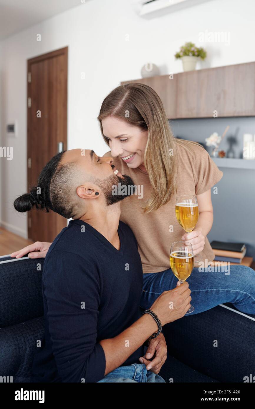 Married couple kissing on sofa hi-res stock photography and images - Alamy