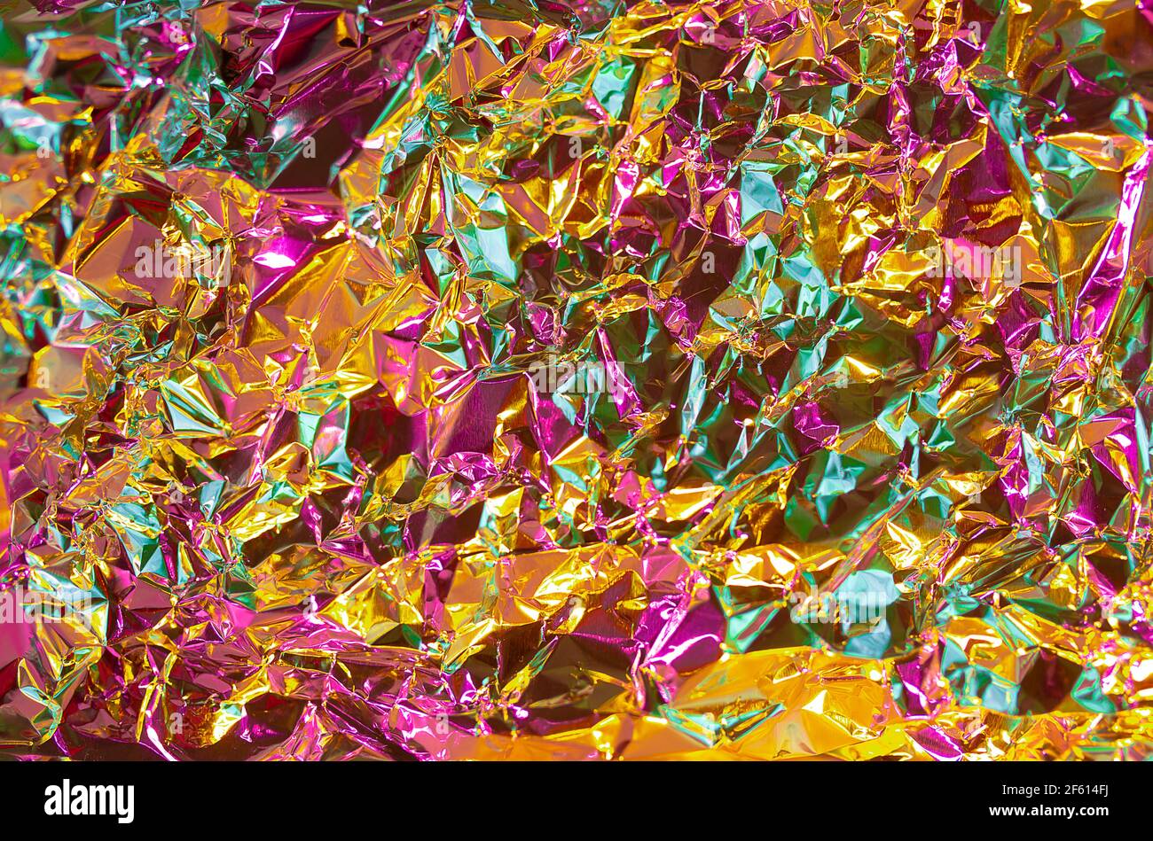https://c8.alamy.com/comp/2F614FJ/gold-texture-effect-with-pink-and-green-multicolor-tint-futuristic-chrome-abstract-crumled-foil-paper-honey-gold-and-juicy-pink-fusion-colors-backgr-2F614FJ.jpg