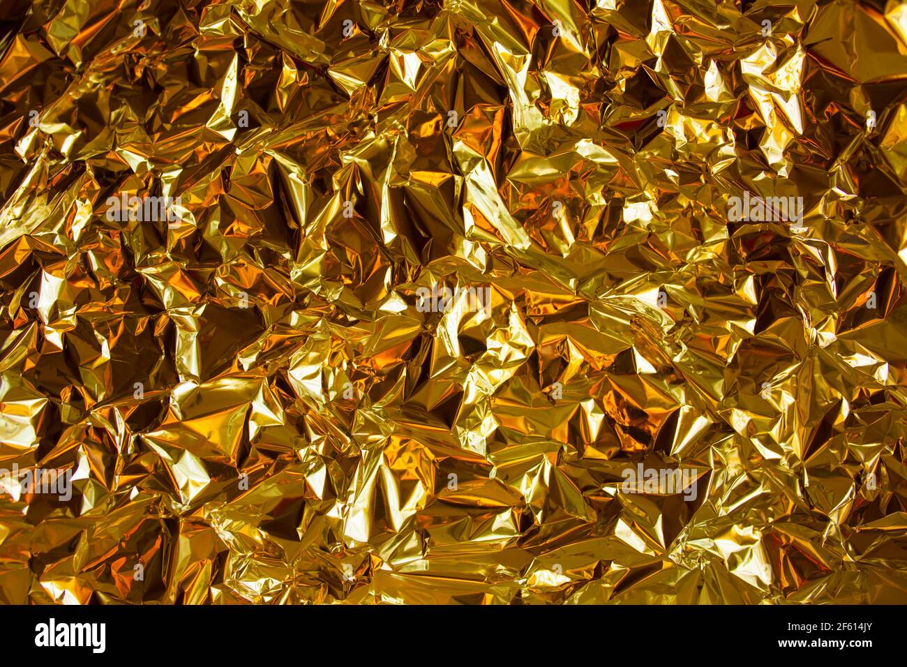 Golden metal chrome foil paper background with bold crumpled texture for  fresh and luxury design. Sparkling rich gold luxury background Stock Photo  - Alamy