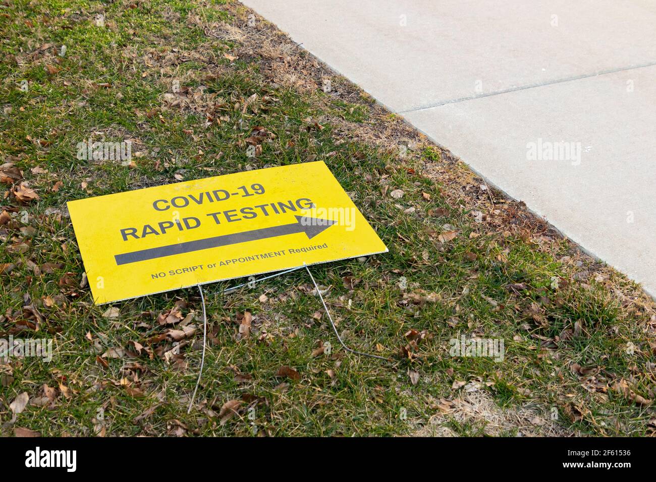 COVID-19 pandemic rapid testing site sign laying on the ground Stock Photo