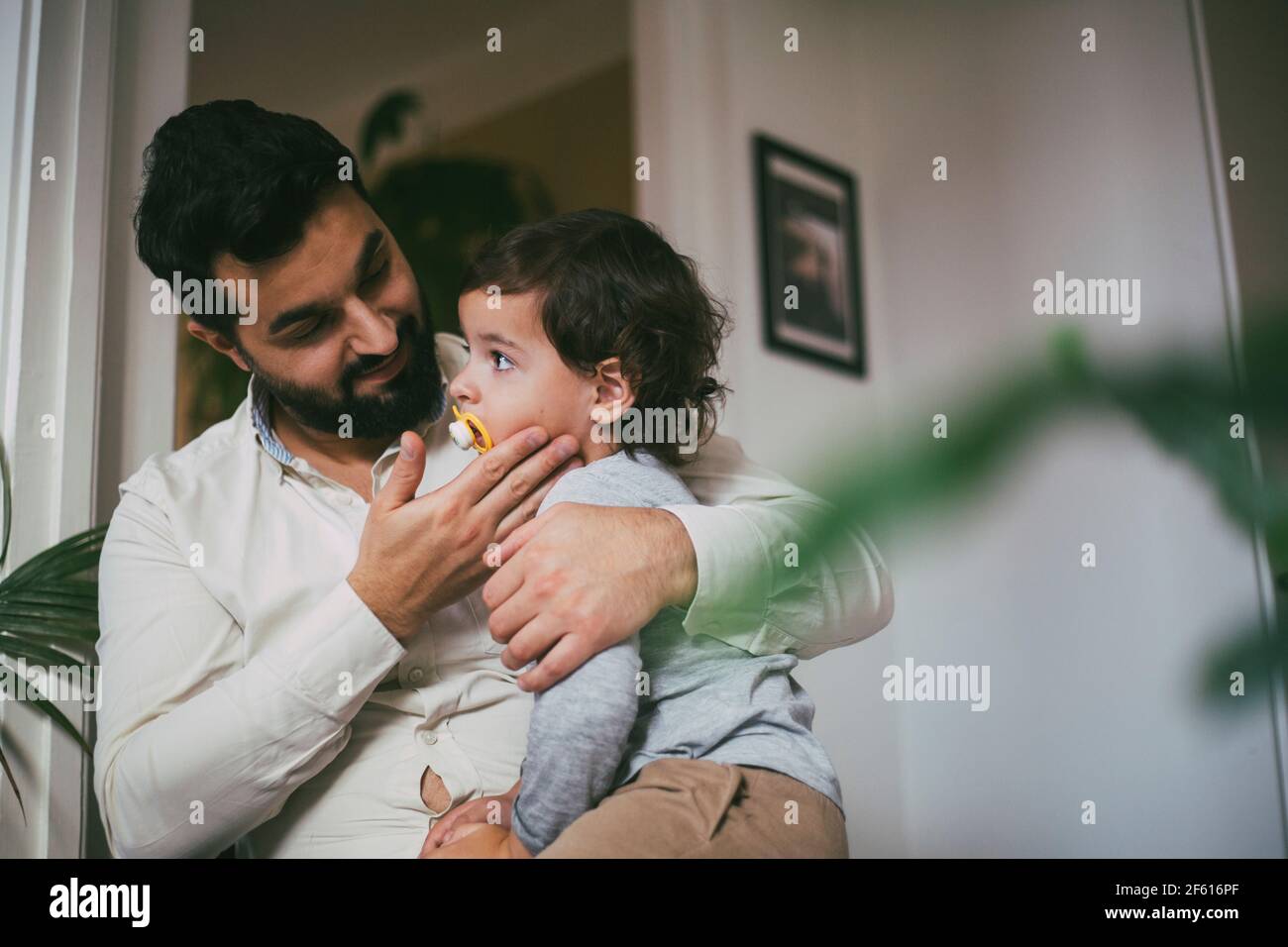 Father embracing son at home Stock Photo