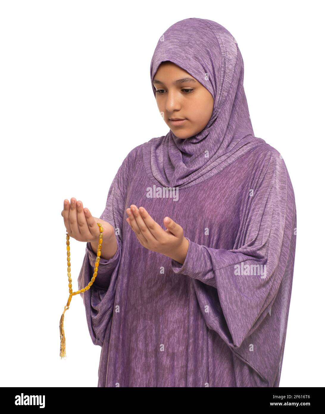 Little Muslim Girl Praying for Allah, Girl with Prayer Costume and Rosary, Ramadan Kareem Concept Stock Photo